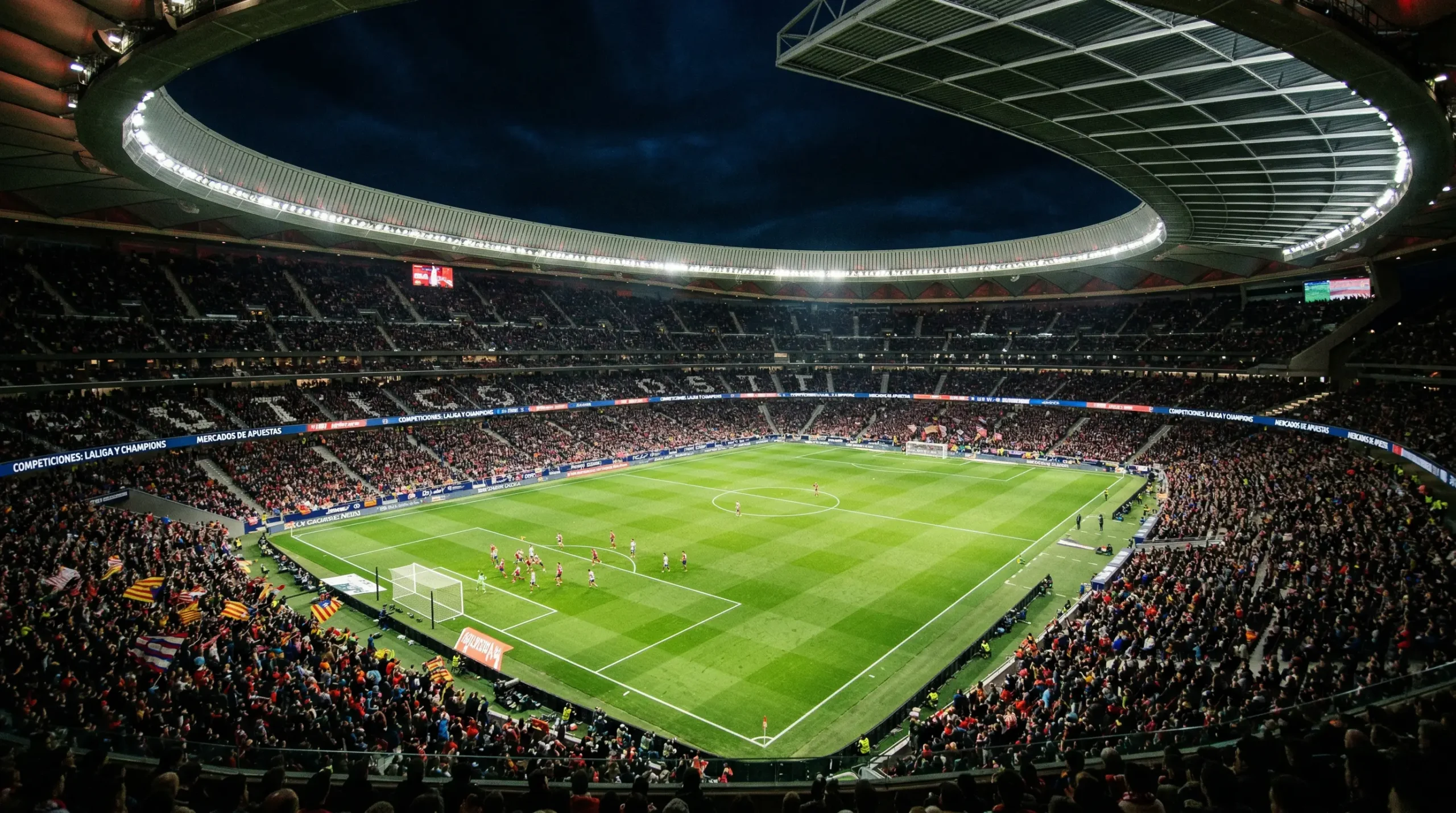 Estadio de fútbol profesional iluminado durante un partido nocturno de LaLiga con las gradas llenas